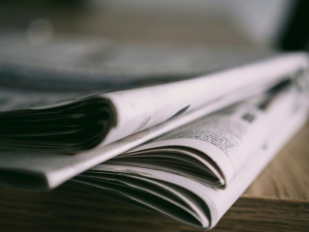 PERM Recruitment Advertising Newspaper Media Placement – Blue Sky 365 Stack of newspapers representing DOL-compliant print media placement for PERM recruitment advertising managed by Blue Sky 365